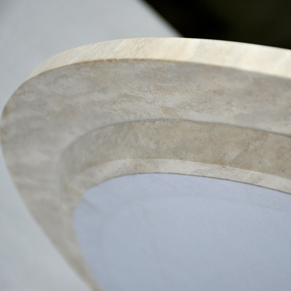 Close-up of Travertine Dining Table Base - Geometric Cutout & Natural Stone Texture Detail