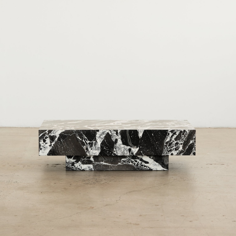 Close-up of black marble coffee table - dramatic white veining and thick slab design