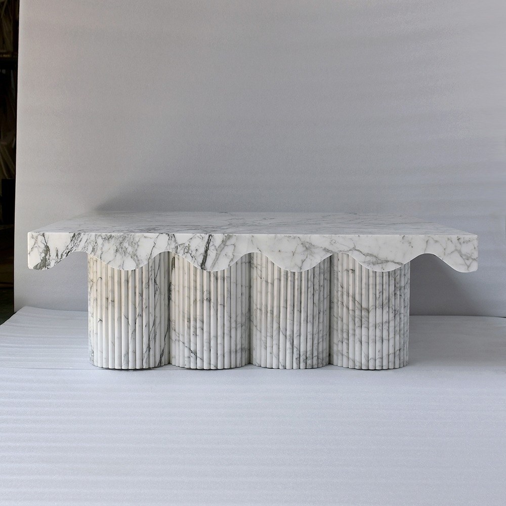 Contemporary marble coffee table with scalloped edge and fluted cylindrical legs